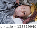 Funny child peeking out from a heap of laundry and laughing. 138819940