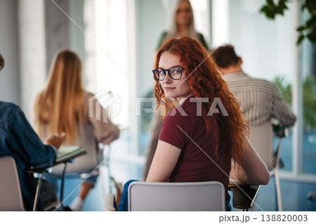 Group of college students attending lecture in university hall. Group of college students attending lecture in university hall. 138820003