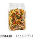 Uncooked tricolor spiral pasta in transparent packaging, isolated studio shot. Healthy Italian food. 138820693