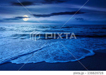 autumn vacation at the sea at night. full moon over beautiful seascape. calm waves wash the sandy beach. image with cloudy sky above horizon. mysterious background for fantasy or ads placement autumn vacation at the sea at night. full moon over beautiful seascape. calm waves wash the sandy beach. image with cloudy sky above horizon. mysterious background for fantasy or ads placement 138820728