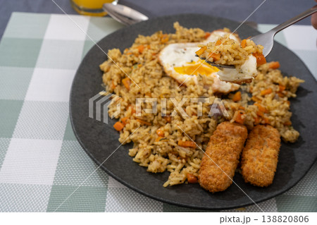 Golden Rice with Fish Fingers and Fried Egg Golden Rice with Fish Fingers and Fried Egg 138820806