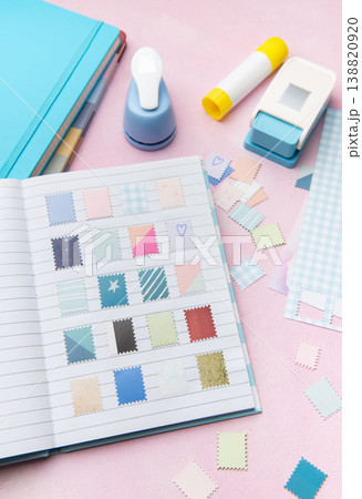Scrapbook journal with decorative crafting paper punches creating diy stamps 138820920