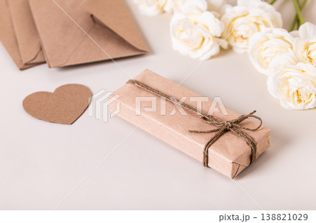 Gift box, heart and roses for Mother's Day on the table 138821029