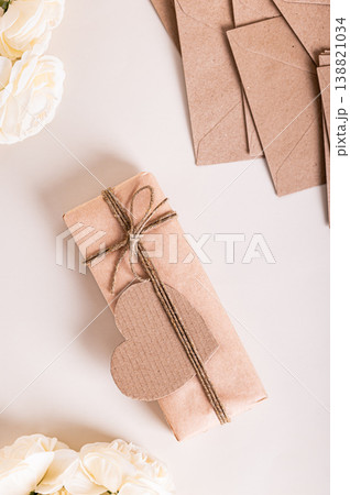 Gift box, heart and roses for Mother's Day on the table top and vertical view Gift box, heart and roses for Mother's Day on the table top and vertical view 138821034