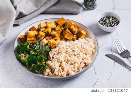 A plate of rice, fried tofu and broccoli on the table A plate of rice, fried tofu and broccoli on the table 138821047