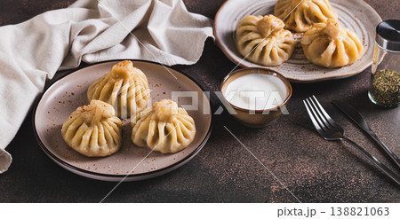 A portion of boiled Georgian khinkali on a plate on the table web banner A portion of boiled Georgian khinkali on a plate on the table web banner 138821063