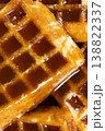 Sweet dessert background with waffles and flowing caramel syrup. 138822337