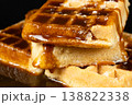Delicious Belgian waffles topped with sweet caramel syrup close up. 138822338