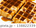 Sweet dessert background with waffles and flowing caramel syrup. 138822339