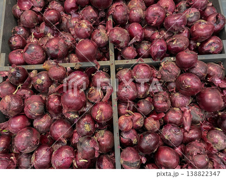 Fresh red onions for sale at a local market during the afternoon in a busy town Fresh red onions for sale at a local market during the afternoon in a busy town 138822347