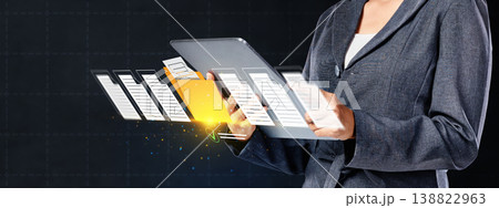 A corporate professional manages electronic files and folders floating from a tablet, illustrating cloud storage, digital transformation, and efficient paperless office solutions A corporate professional manages electronic files and folders floating from a tablet, illustrating cloud storage, digital transformation, and efficient paperless office solutions 138822963