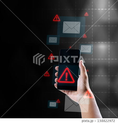 A person holding a smartphone showing a red warning triangle alert, surrounded by floating email icons and warning signs, representing phishing, cyber threats, and mobile security risks A person holding a smartphone showing a red warning triangle alert, surrounded by floating email icons and warning signs, representing phishing, cyber threats, and mobile security risks 138822972