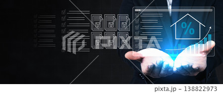 A businessman holds a digital interface displaying house icons, percentage symbols, and growth charts, representing mortgage interest rates and real estate investment data analysis A businessman holds a digital interface displaying house icons, percentage symbols, and growth charts, representing mortgage interest rates and real estate investment data analysis 138822973