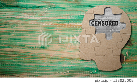 Conceptual image of a human head made of puzzle pieces with the word CENSORED visible in a missing gap, representing thought control and restricted information Conceptual image of a human head made of puzzle pieces with the word CENSORED visible in a missing gap, representing thought control and restricted information 138823009