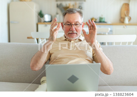 Happy middle aged senior man with laptop talk on video call with friends family. Mature old senior grandfather having fun talking with grown up children online. Older generation modern tech usage 138823604