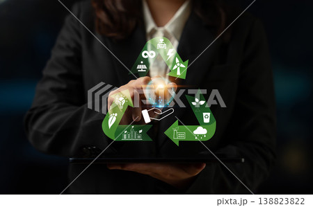 Business Professional Touching Digital Recycling Icon with Energy, Water, and Environment Symbols in a Dark Setting Quark 138823822