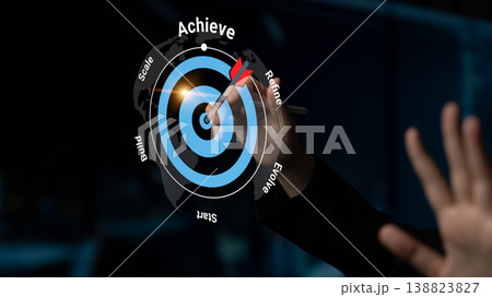 Focus on achievement through visual goals and strategy concept with a dart hitting the target representing success and progress in business performance Gantry 138823827