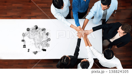 Diverse Team Collaborating on Project with Global Icons on Table, Symbolizing Teamwork and Innovation for Business Solutions and Strategies Trope 138824105