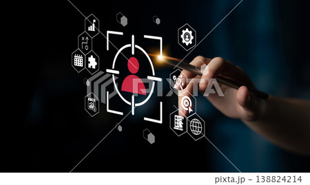 Modern technology concept with hand holding pen, targeting user profile with digital analytics icons in a dark background setting for innovative solutions Gantry 138824214