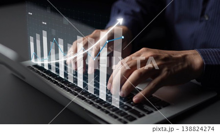 Hands typing on a laptop with graphic overlay showing financial graphs and trends in a modern business environment for data analysis and reporting Copula Hands typing on a laptop with graphic overlay showing financial graphs and trends in a modern business environment for data analysis and reporting Copula 138824274