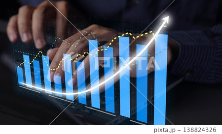 Hands Typing on a Keyboard with Digital Graph Overlay Showing Growth Trend and Data Analysis in a Modern Office Environment Copula 138824326