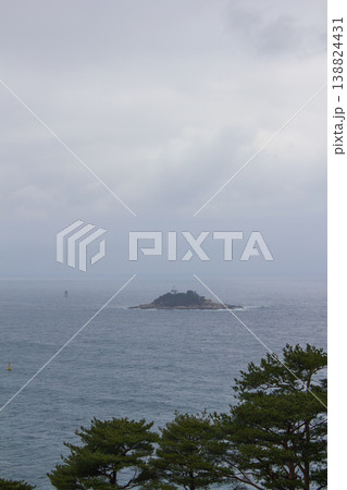 It is a quiet seascape with a small island. It is a quiet seascape with a small island. 138824431