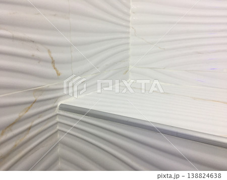 Close view of textured white wall corner with lines showing surface detail and design in a room at a modern building Close view of textured white wall corner with lines showing surface detail and design in a room at a modern building 138824638
