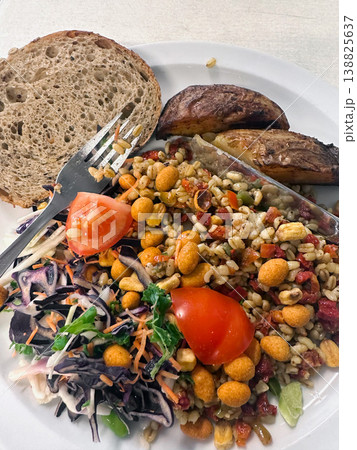Vegan healthy meal with grains vegetables and bread on plate. Vegan healthy meal with grains vegetables and bread on plate. 138825637