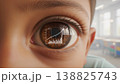 A child stares with wide brown eyes. Reflection shows a growth chart.  138825743