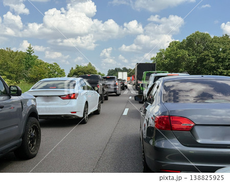 Rows of passenger cars stand closely together on a crowded highway during daytime travel. The image shows commuting conditions, transportation pressure, and real road congestion. Rows of passenger cars stand closely together on a crowded highway during daytime travel. The image shows commuting conditions, transportation pressure, and real road congestion. 138825925