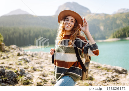 Adventure woman feeling happy among amazing mountains, forest and lake, enjoy the nature landscape Adventure woman feeling happy among amazing mountains, forest and lake, enjoy the nature landscape 138826171