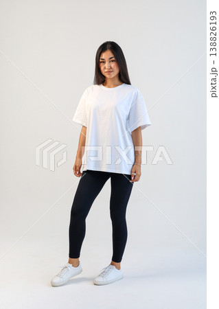 Athletic Asian Model. Vibrant fulllength portrayal of Asian personal trainer in activewear for branding 138826193