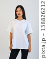 Female model standing straight with white Tshirt against neutral background for catalog display 138826212