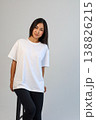 Ecommerce promotional image showcasing confident woman wearing white tshirt in studio setting 138826215