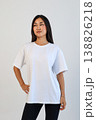 Ecommerce promotional image showcasing confident woman wearing white tshirt in studio setting 138826218
