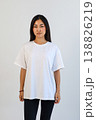 Front view of woman in white shirt. Studio portrait of woman in casual attire with blank background 138826219