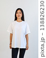 Front view of woman in white shirt. Studio portrait of woman in casual attire with blank background 138826230