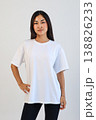 Ecommerce promotional image showcasing confident woman wearing white tshirt in studio setting 138826233
