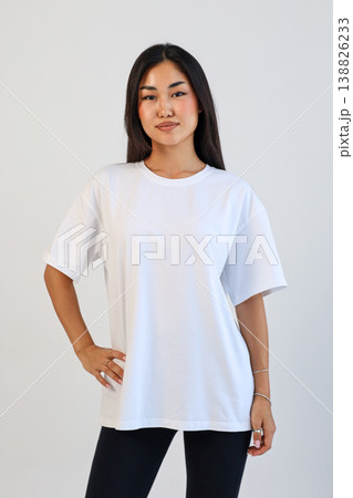 Ecommerce promotional image showcasing confident woman wearing white tshirt in studio setting Ecommerce promotional image showcasing confident woman wearing white tshirt in studio setting 138826233
