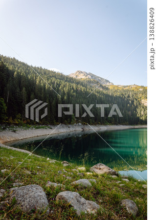 Incredible view in mountains of the lake. Rocky shore of mountain lake in the morning. Incredible view in mountains of the lake. Rocky shore of mountain lake in the morning. 138826409