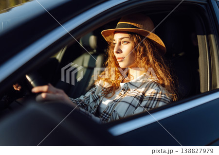 Beautiful young woman driving her car. Woman traveler. Summer vacation and adventure. Beautiful young woman driving her car. Woman traveler. Summer vacation and adventure. 138827979