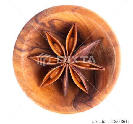 Star anise isolated on white background. Anise stars or badian spice in wooden bowl. Clipping path. Top view. 138828630