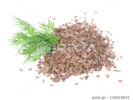 Dried dill seeds with a small bunch of fresh green dill isolated on white background. Dried dill seeds with a small bunch of fresh green dill isolated on white background. 138828645