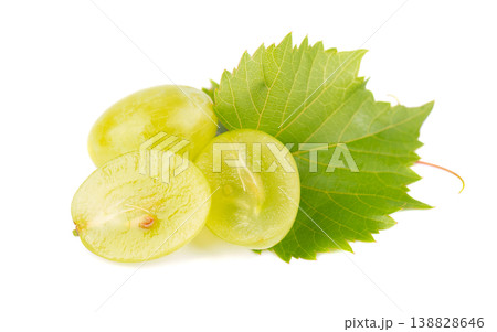 Green grape slices with fresh vine leaf and sprout isolated on white background. Green grape slices with fresh vine leaf and sprout isolated on white background. 138828646