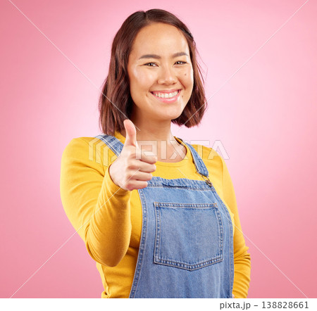 Smile, thumbs up and yes with portrait of woman in studio for support, agreement and motivation. Winner, emoji and success with person on pink background for achievement, thank you and vote sign 138828661
