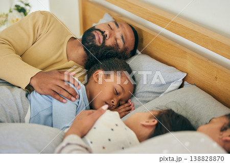 Sleeping, comfort and family in bed relax, resting and dreaming in their home together. Peaceful, sleep and parents embrace children in bedroom for nap, relaxation or cozy, love and sweet on weekend 138828870
