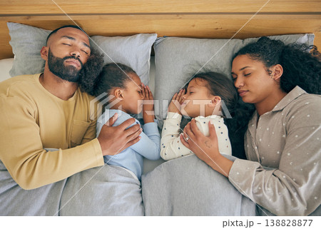 Sleeping, family and relax in bed from above, relax and resting in their home on the weekend. Sleeping, comfort and top view of parents embracing children in a bedroom with love, nap and dreaming 138828877
