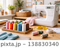 Sewing machine with colorful threads and fabric on cozy workspace table 138830340