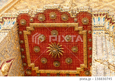 Tiny mirror pieces and gold surfaces show careful exterior work from the Rattanakosin era. The close framing reveals patient traditional craft. Tiny mirror pieces and gold surfaces show careful exterior work from the Rattanakosin era. The close framing reveals patient traditional craft. 138830745