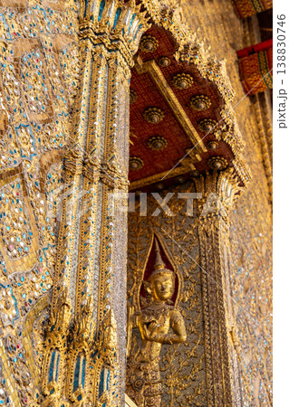 Tiny mirror pieces and gold surfaces show careful exterior work from the Rattanakosin era. The close framing reveals patient traditional craft. Tiny mirror pieces and gold surfaces show careful exterior work from the Rattanakosin era. The close framing reveals patient traditional craft. 138830746